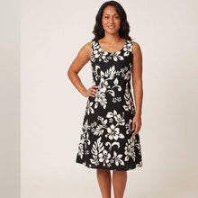 Load image into Gallery viewer, Woman wearing an elegant black Original Hibiscus Hawaiian dress for women, an A-line knee-length women's Aloha dress handmade in Hawaii.
