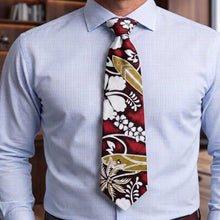 Load image into Gallery viewer, Man wearing a light blue dress shirt with a colorful tie featuring floral and abstract patterns.