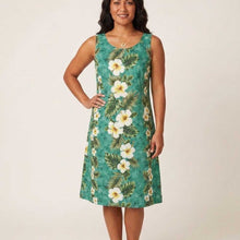 Load image into Gallery viewer, Woman wearing a floral hawaiian dress with a green background