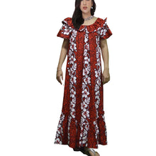 Load image into Gallery viewer, A woman wearing a traditional red Hawaiian muumuu dress with a tropical floral pattern.