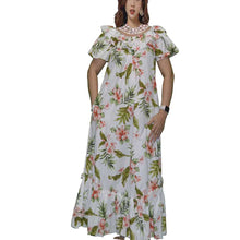 Load image into Gallery viewer, A woman wearing a long cotton Muumuu dress with a tropical floral pattern. The dress features cap sleeves, a ruffled hem, and is near ankle length.