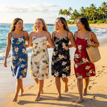 Load image into Gallery viewer, Four women wearing short Hawaiian dresses walking on a beach with classic orchid floral in the background.
