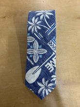 Load image into Gallery viewer, A navy blue necktie with a tropical Hawaiian print featuring white palm trees, plumeria flowers, a white paddleboard, and light blue accents, laid flat on a light brown wooden surface.
