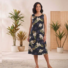 Load image into Gallery viewer, Woman wearing a floral dress standing in a room with plants
