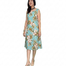 Load image into Gallery viewer, Woman wearing a midi dress with orchid floral dress on a green background
