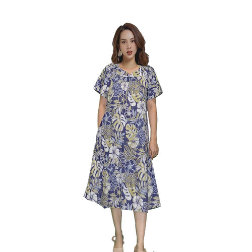 A woman wearing a blue and green floral Muumuu dress with short sleeves and a sweetheart neckline, standing against a white background.